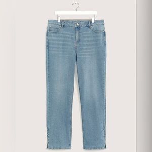 Addition Elle straight leg jeans with side slit in medium denim.